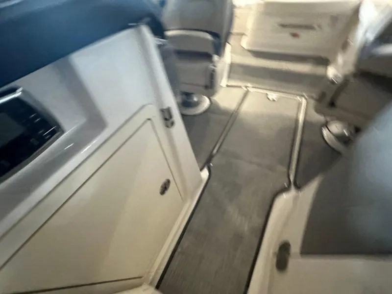 Slide: The Image of Interior view of 2018 Chaparral 244 Sunesta boat, featuring seating and storage areas. - 42