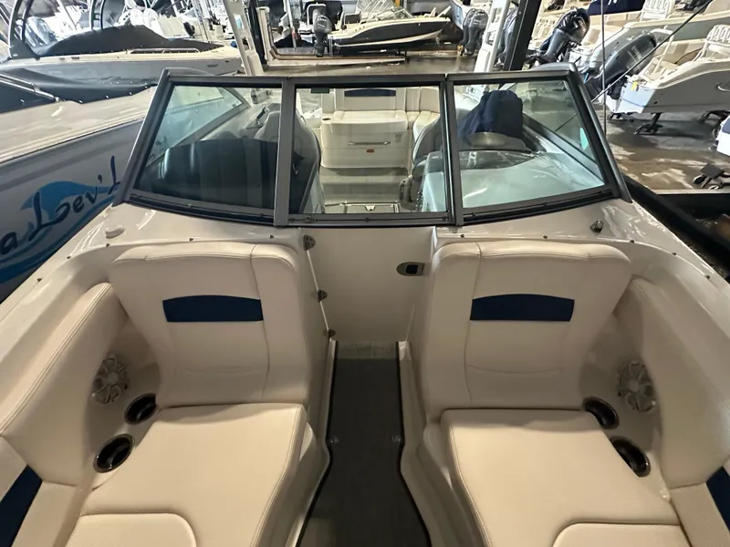 Slide: The Image of 2018 Chaparral 244 Sunesta boat interior with seating and windshield in showroom. - 45