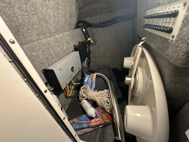 Slide: The Image of Interior storage compartment of a 2018 Chaparral 244 Sunesta boat with equipment and accessories. - 46
