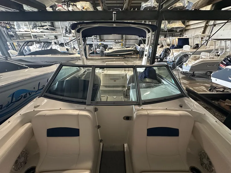 Slide: The Image of 2018 Chaparral 244 Sunesta boat interior with seating, stored in a marina. - 47