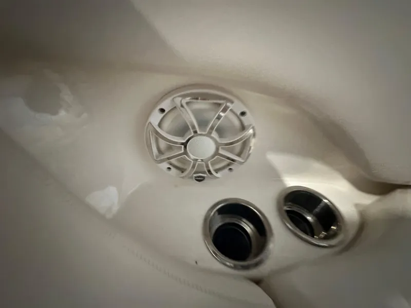 Slide: The Image of 2018 Chaparral 244 Sunesta boat interior with speaker and cup holders. - 48