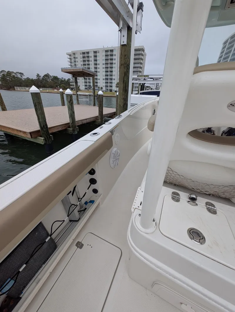 Slide: The Image of 2019 Sailfish 290cc boat docked near waterfront buildings on a cloudy day. - 11