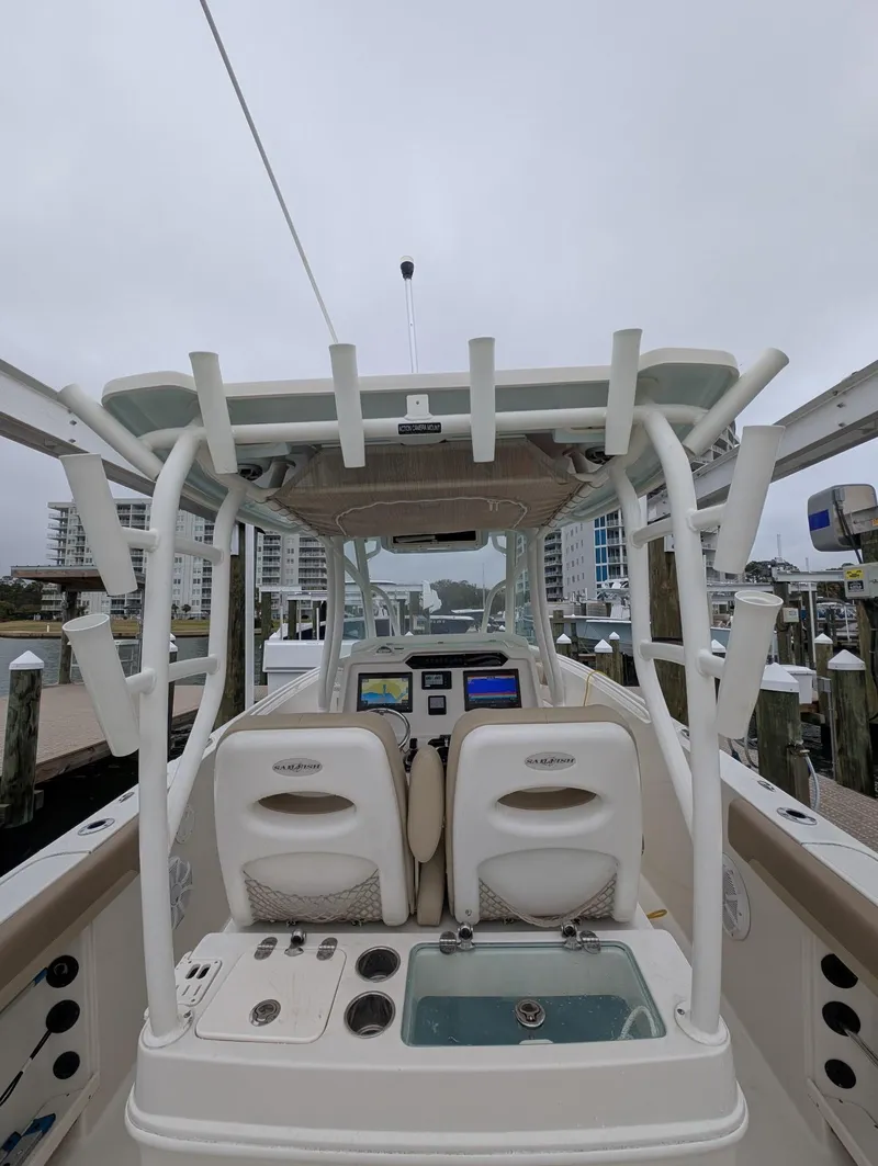 Slide: The Image of 2019 Sailfish 290cc boat with dual seats and navigation equipment at a dock. - 8