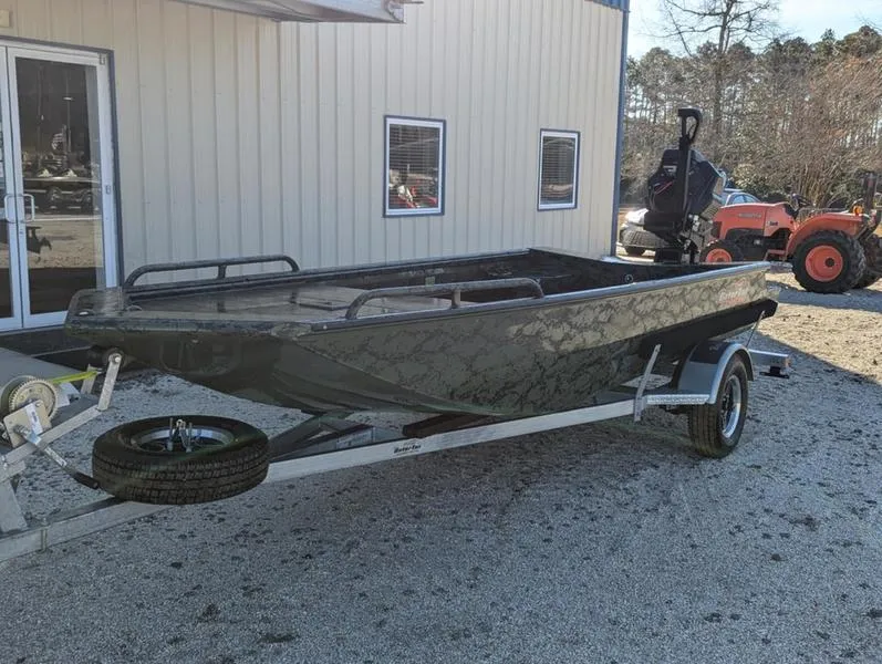 Slide: The Image of 2025 Gator Tail 1750 Savage Series boat on trailer, parked outside a building. - 11