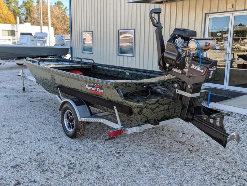 Slide: The Image of 2025 Gator Tail 1750 Savage Series boat on trailer, parked outside a building. - 12