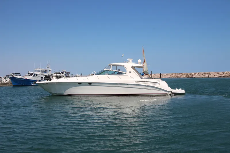 Slide: The Image of 2003 Sea Ray 550 Sundancer yacht cruising in a calm harbor. - 1