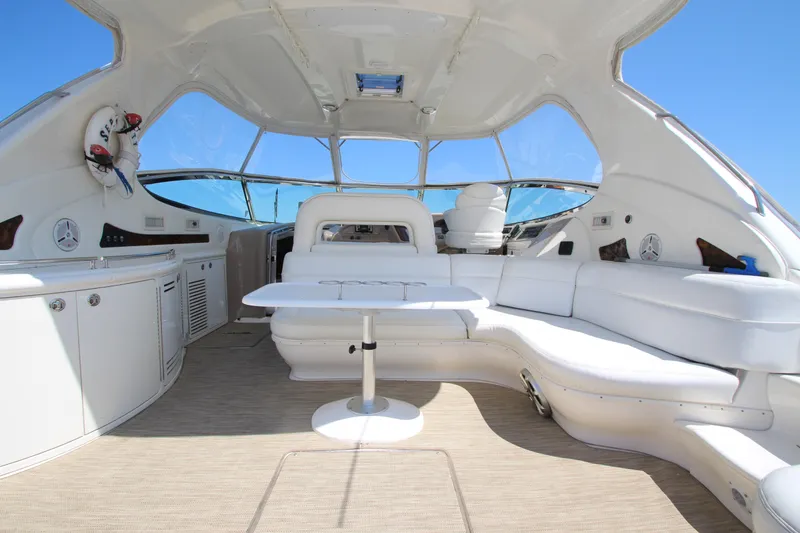 Slide: The Image of Luxurious interior of 2003 Sea Ray 550 Sundancer yacht with white seating and table. - 13
