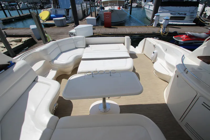 Slide: The Image of 2003 Sea Ray 550 Sundancer yacht with spacious seating and table on deck. - 17