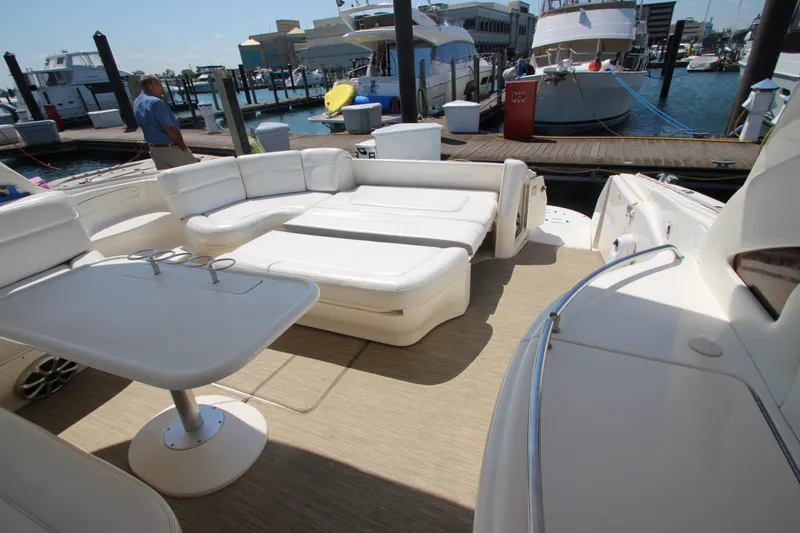 Slide: The Image of 2003 Sea Ray 550 Sundancer yacht with spacious deck seating at marina. - 19