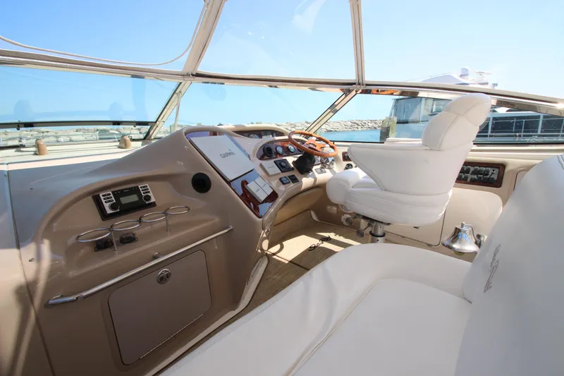 Slide: The Image of 2003 Sea Ray 550 Sundancer helm with luxurious seating and modern controls. - 23