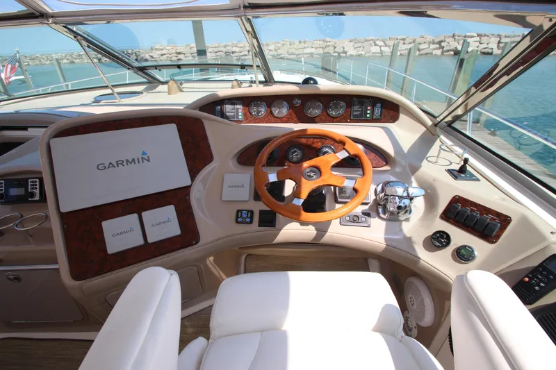 Slide: The Image of Helm of 2003 Sea Ray 550 Sundancer with Garmin navigation, wooden steering wheel, and gauges. - 25