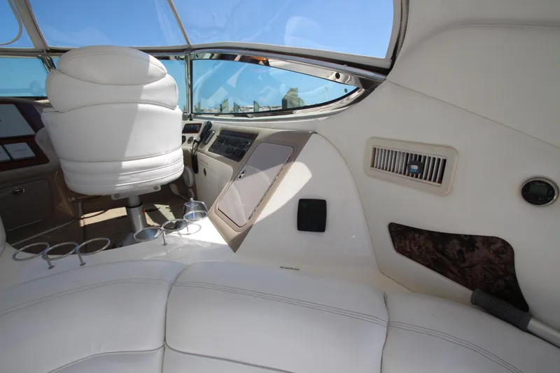 Slide: The Image of Interior of 2003 Sea Ray 550 Sundancer yacht with white seating and control panel. - 26