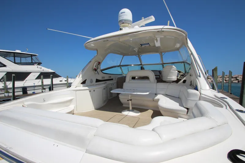 Slide: The Image of 2003 Sea Ray 550 Sundancer yacht with spacious white seating and sleek design. - 3