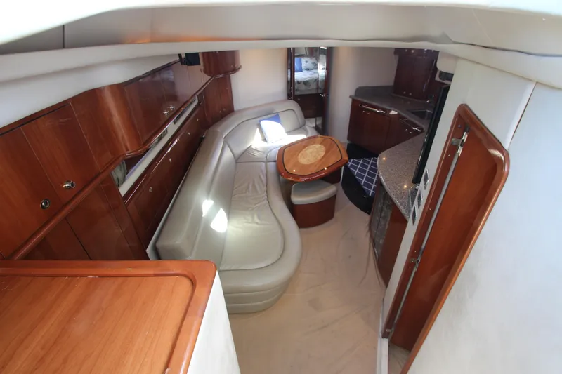 Slide: The Image of Luxurious interior of 2003 Sea Ray 550 Sundancer yacht with leather seating and wooden cabinetry. - 31