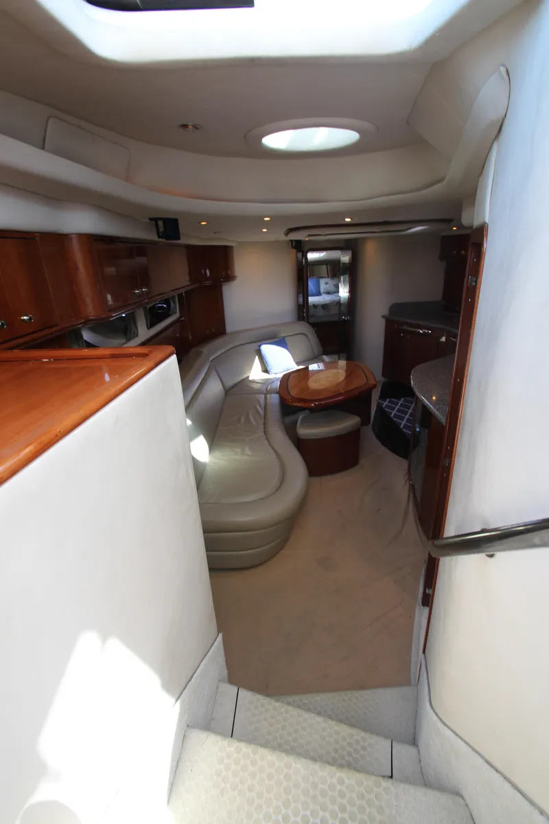 Slide: The Image of Interior of 2003 Sea Ray 550 Sundancer yacht with elegant seating and wooden cabinetry. - 32
