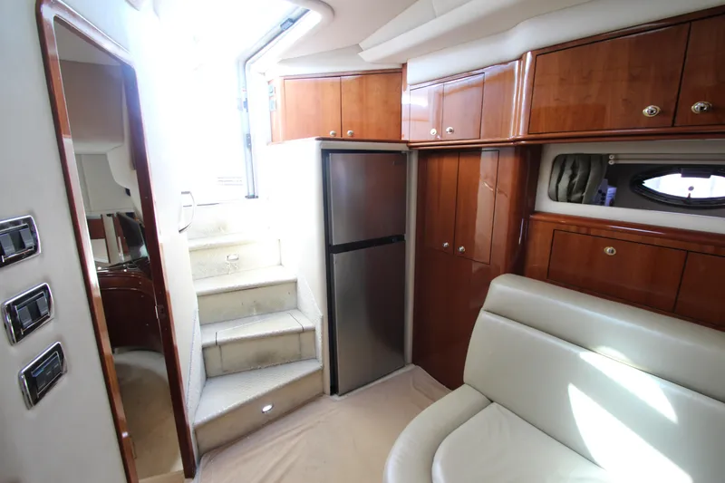 Slide: The Image of Interior of 2003 Sea Ray 550 Sundancer yacht with stairs, cabinets, and seating area. - 34