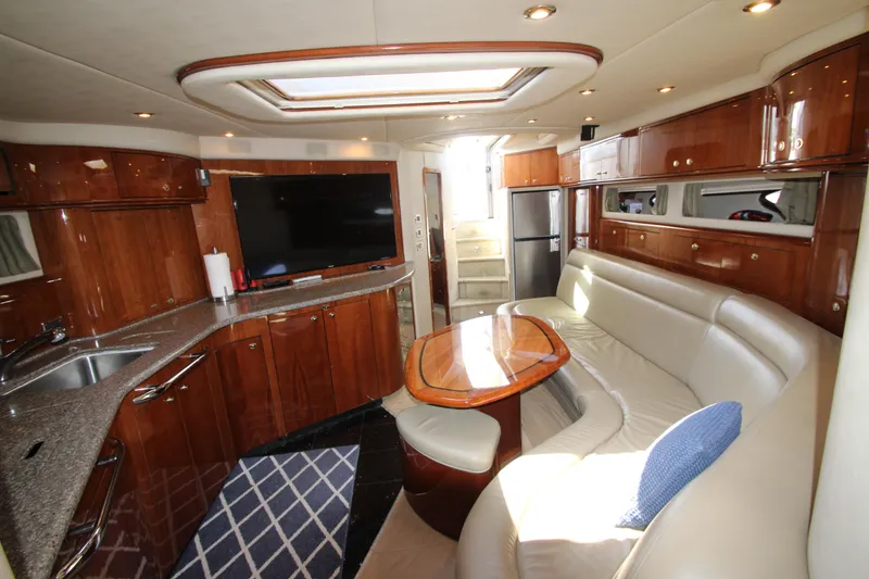 Slide: The Image of Luxurious interior of 2003 Sea Ray 550 Sundancer yacht with modern kitchen and seating area. - 36