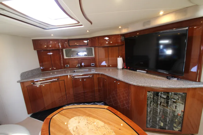 Slide: The Image of Luxurious interior of 2003 Sea Ray 550 Sundancer yacht with modern kitchen and entertainment area. - 39