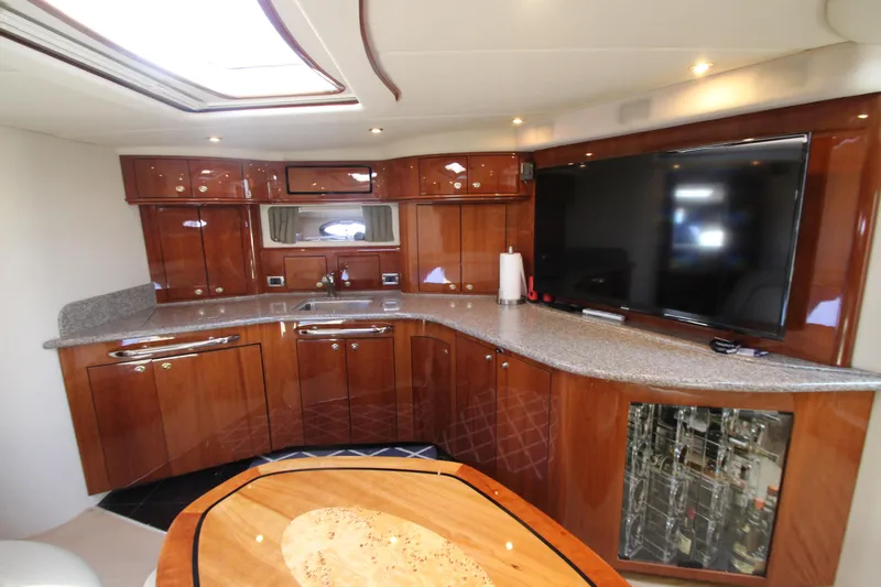 Slide: The Image of Luxurious interior of 2003 Sea Ray 550 Sundancer yacht with modern kitchen and entertainment area. - 40