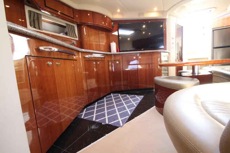 Slide: The Image of Luxurious 2003 Sea Ray 550 Sundancer yacht interior with polished wood cabinetry and modern amenities. - 42