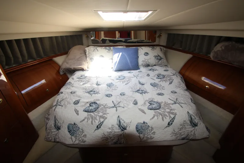 Slide: The Image of Luxurious cabin interior of 2003 Sea Ray 550 Sundancer with nautical-themed bedding. - 43