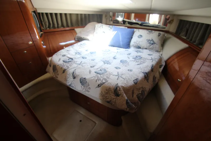Slide: The Image of Luxurious cabin interior of 2003 Sea Ray 550 Sundancer with cozy bed and elegant wood finish. - 44