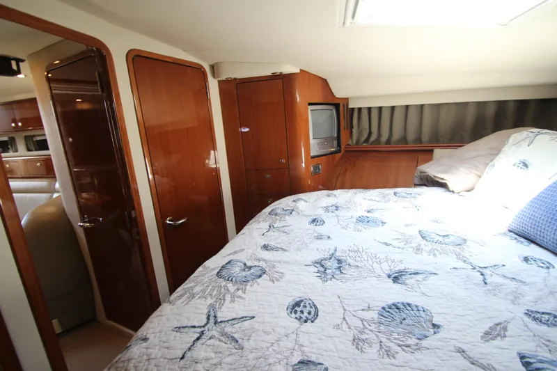 Slide: The Image of Luxurious cabin interior of 2003 Sea Ray 550 Sundancer with nautical-themed bedding. - 45