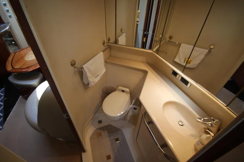 Slide: The Image of 2003 Sea Ray 550 Sundancer yacht bathroom with sink, toilet, and mirror. - 47