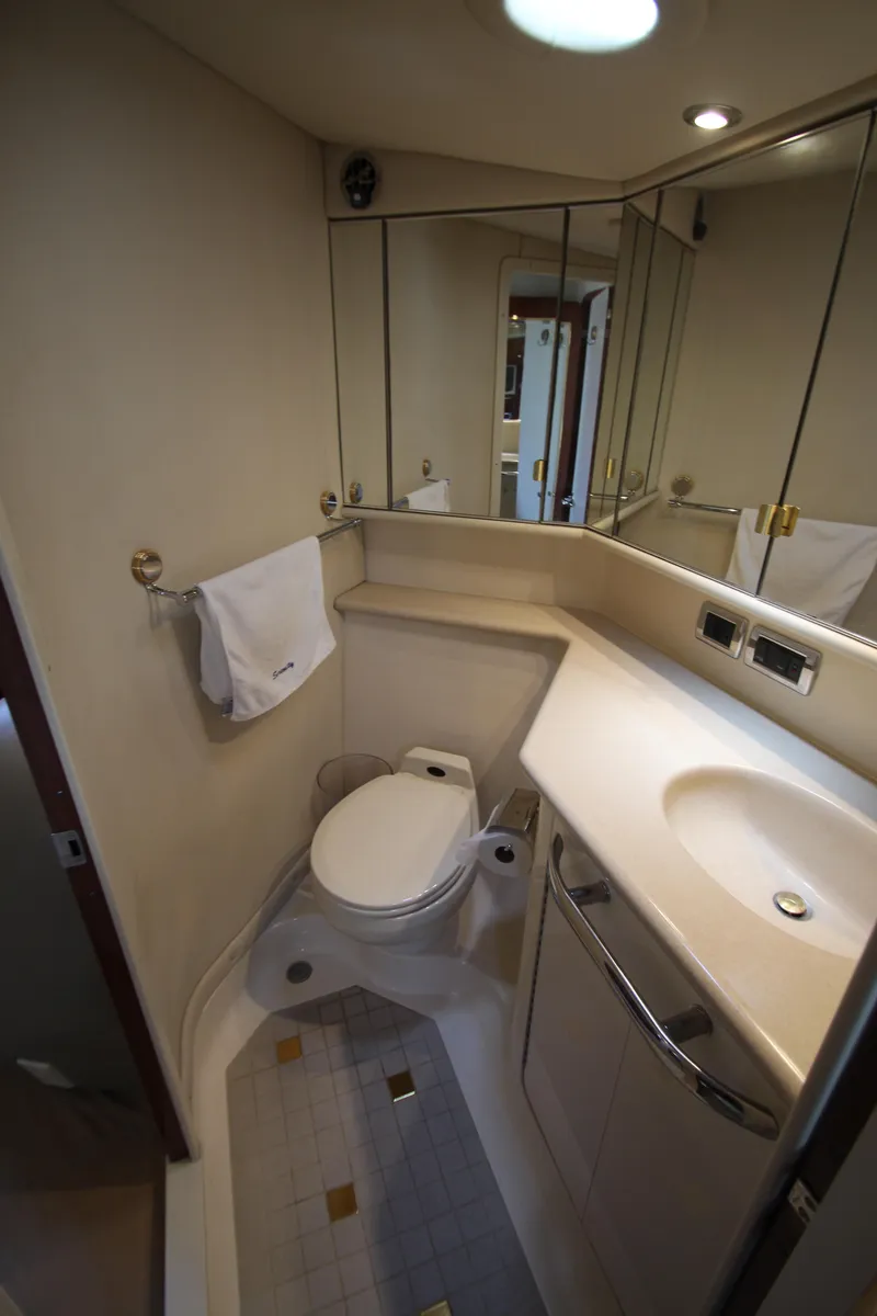 Slide: The Image of Bathroom interior of 2003 Sea Ray 550 Sundancer yacht, featuring modern fixtures and mirrors. - 48
