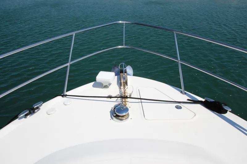 Slide: The Image of Bow view of 2003 Sea Ray 550 Sundancer yacht on calm water. - 8