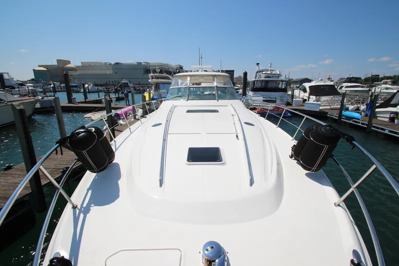 Slide: The Image of 2003 Sea Ray 550 Sundancer yacht docked at marina under clear blue sky. - 9