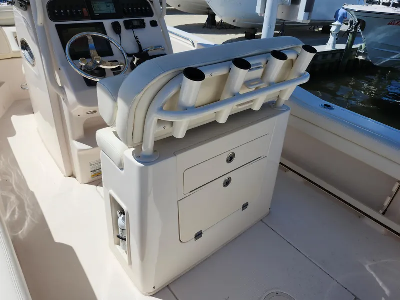 Slide: The Image of 2021 Grady-White Fisherman 236 boat interior with rod holders and steering console. - 10