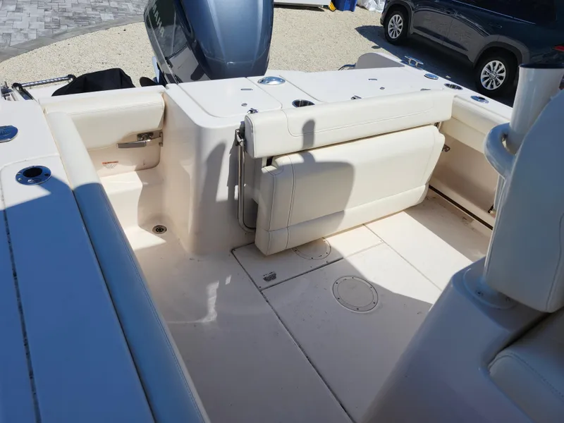 Slide: The Image of 2021 Grady-White Fisherman 236 boat interior with foldable seating and engine view. - 12