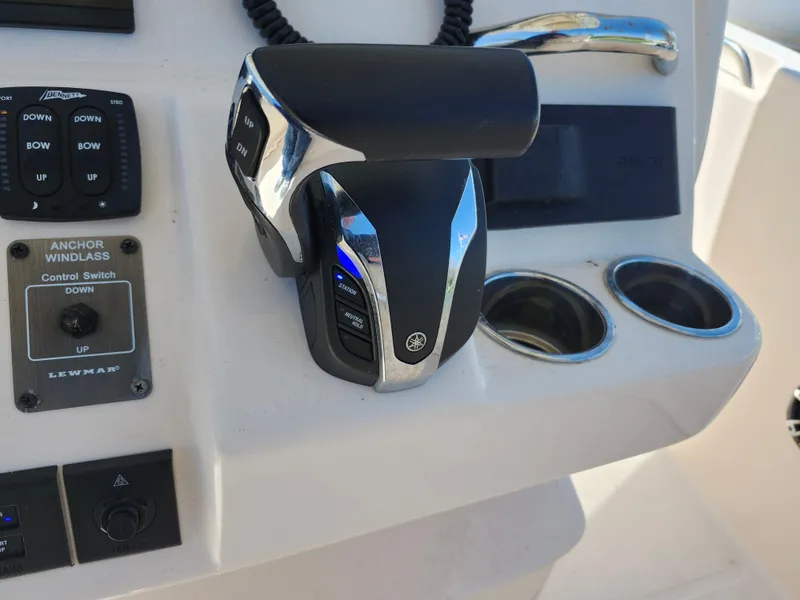 Slide: The Image of Control panel of 2021 Grady-White Fisherman 236 boat with throttle and switches. - 16