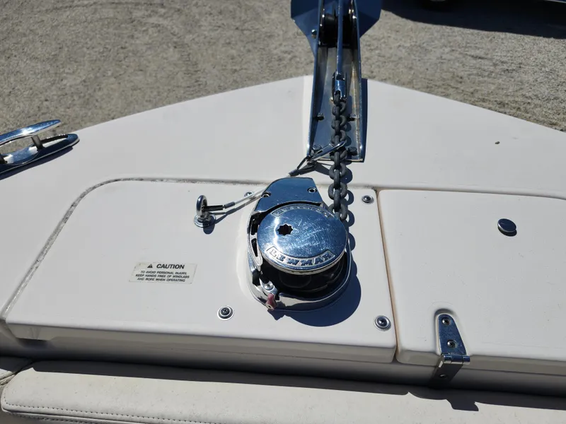 Slide: The Image of 2021 Grady-White Fisherman 236 boat anchor system on deck, featuring a winch and chain. - 17