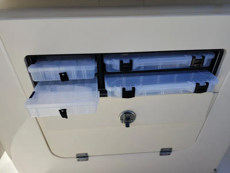 Slide: The Image of Storage compartment with tackle boxes on a 2021 Grady-White Fisherman 236 boat. - 19