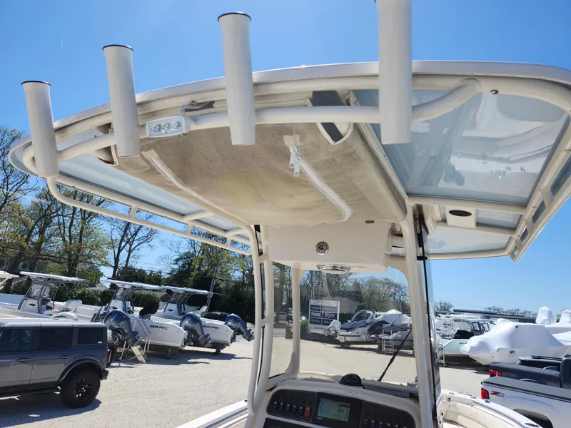 Slide: The Image of 2021 Grady-White Fisherman 236 boat with T-top and rod holders in a marina. - 20