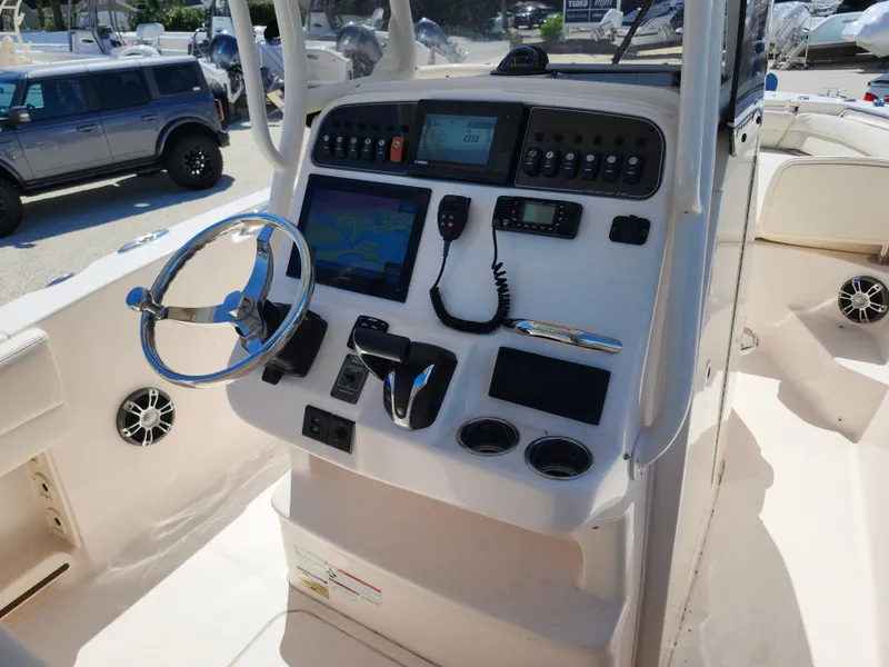 Slide: The Image of 2021 Grady-White Fisherman 236 boat console with steering wheel, navigation, and control panel. - 6