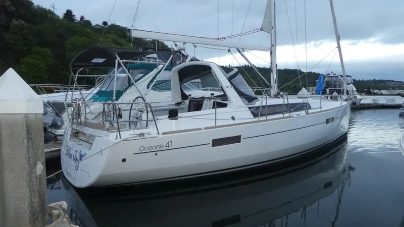 Slide: The Image of 2014 Beneteau Oceanis 41 sailboat docked in a marina, side view. - 0