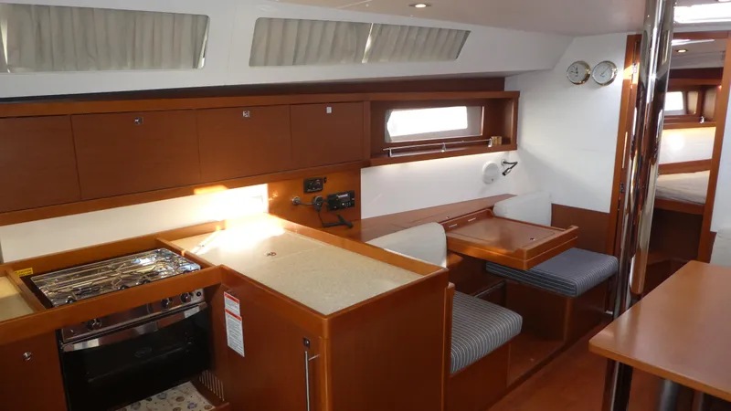 Slide: The Image of Interior of 2014 Beneteau Oceanis 41 yacht with kitchen and dining area. - 15