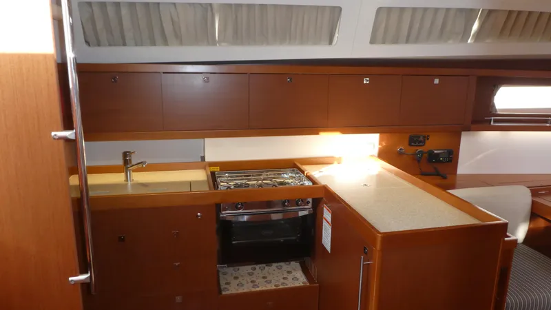 Slide: The Image of Interior view of 2014 Beneteau Oceanis 41 yacht kitchen with wood cabinetry and modern appliances. - 16