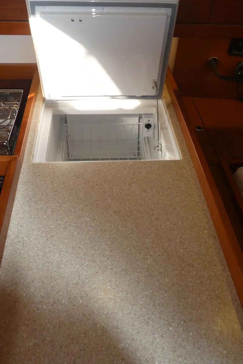 Slide: The Image of Beneteau Oceanis 41 (2014) yacht interior with open built-in refrigerator. - 19
