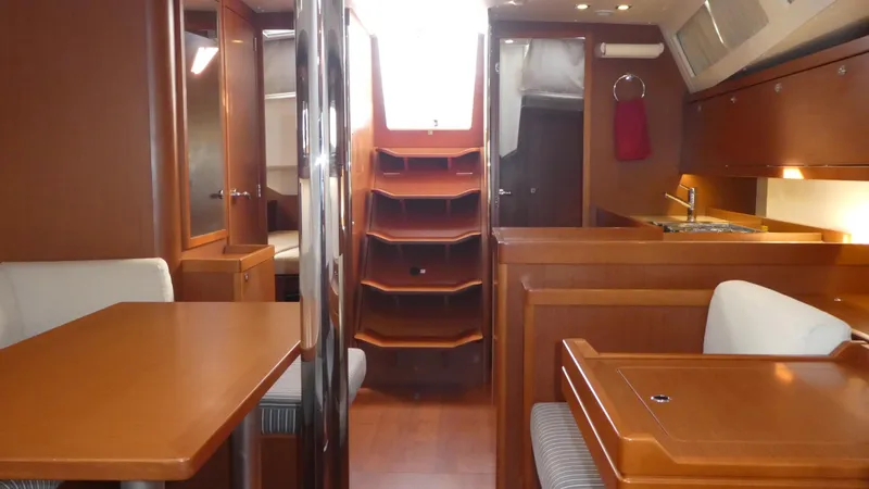 Slide: The Image of Interior of 2014 Beneteau Oceanis 41 sailboat with wood finish and seating area. - 23