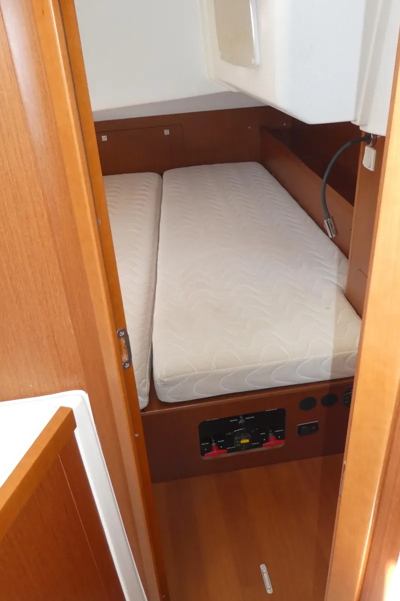 Slide: The Image of Cabin interior of 2014 Beneteau Oceanis 41 sailboat with twin beds and wooden finish. - 24