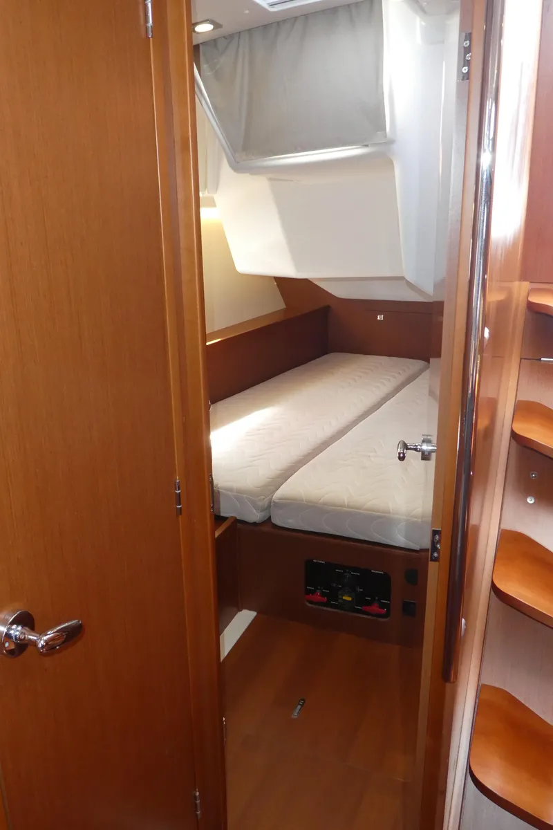 Slide: The Image of 2014 Beneteau Oceanis 41 cabin interior with bed and wooden finishes. - 27