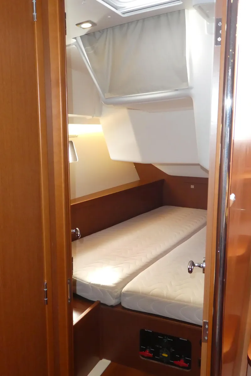 Slide: The Image of 2014 Beneteau Oceanis 41 cabin interior with cozy bed and wooden finish. - 28