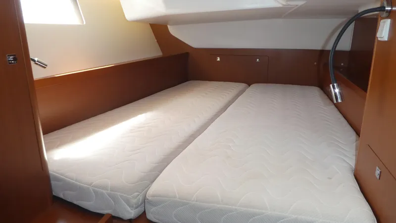 Slide: The Image of Cabin interior of 2014 Beneteau Oceanis 41 with twin mattresses and wooden finish. - 29