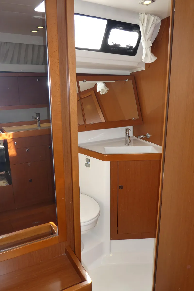 Slide: The Image of 2014 Beneteau Oceanis 41 yacht bathroom with wooden cabinetry and modern fixtures. - 31