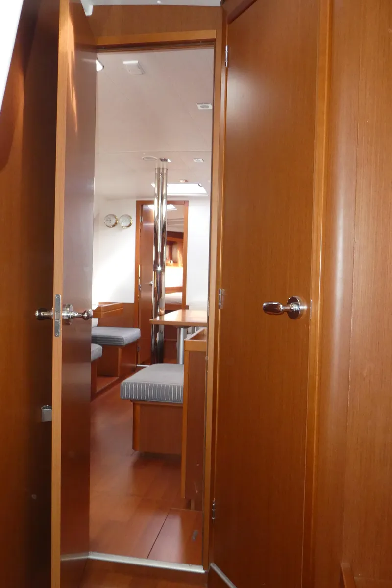 Slide: The Image of Interior view of 2014 Beneteau Oceanis 41 sailboat, featuring wooden doors and cozy cabin space. - 35