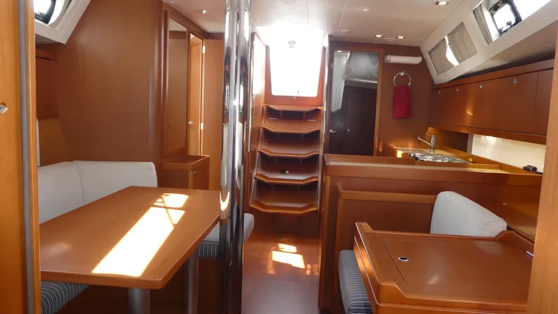 Slide: The Image of Interior of 2014 Beneteau Oceanis 41 sailboat with wood finish and dining area. - 36